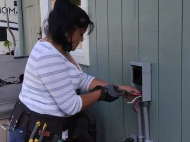 Licensed electrician wiring an exterior subpanel in San Tan Valley